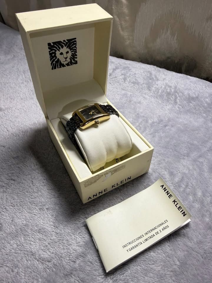 Anne Klein Rectangular Two-Tone Ceramic Watch with Box (Category: Women's Watches) located in Caloocan City. Submitted by Appareildemusique (Listing ID 1468558224, Image 2). Description: - Brand: Anne Klein - Dial: Rectangular black dial with gold-tone case - Strap: Ceramic and metal bracelet - Condition: Brand new with original branded presentation box, price tag, and international warranty booklet - Style: Classic, versatile for casual or forma