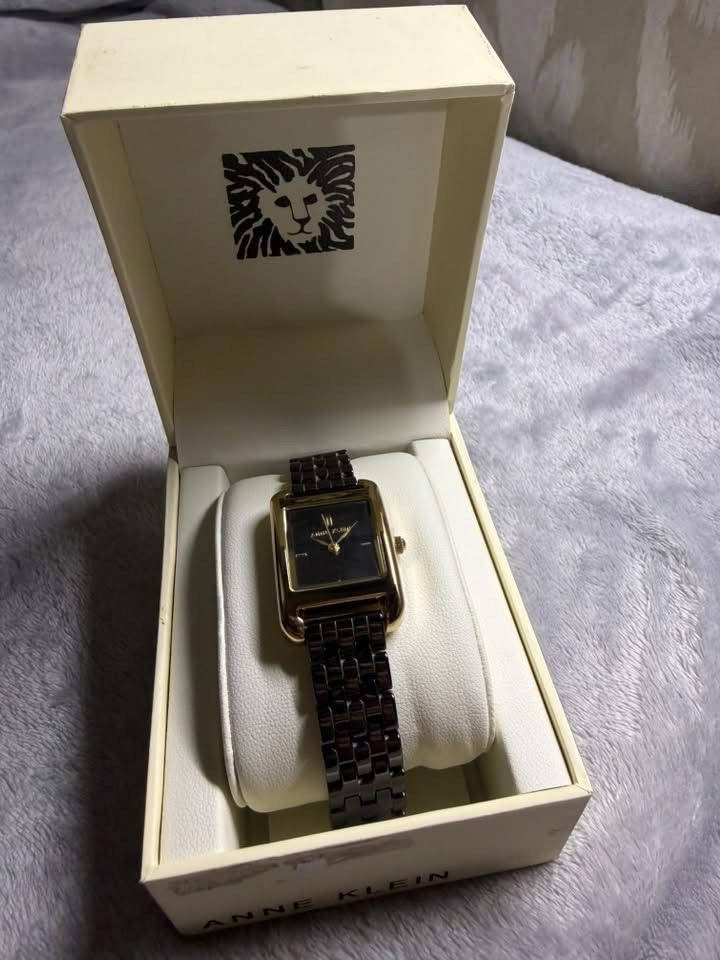 Anne Klein Rectangular Two-Tone Ceramic Watch with Box (Category: Women's Watches) located in Caloocan City. Submitted by Appareildemusique (Listing ID 1468558224, Image 1). Description: - Brand: Anne Klein - Dial: Rectangular black dial with gold-tone case - Strap: Ceramic and metal bracelet - Condition: Brand new with original branded presentation box, price tag, and international warranty booklet - Style: Classic, versatile for casual or forma