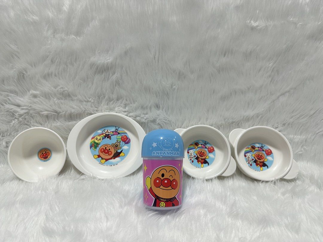 Anpanman Baby Plates and Drinking Cup Set (Category: Dinnerware & Cutlery) located in Cavite. Submitted by kobebean_122 (Listing ID 1468634759, Image 1). Description: - Complete Anpanman kids mealtime set - Set includes: 1 small bowl, 1 oval plate, 2 handled bowls with cute character graphics inside, and 1 tall storage container with a blue lid - Made of durable, high-quality white plastic/melamine - Fun cartoon design perfect for toddlers and yo