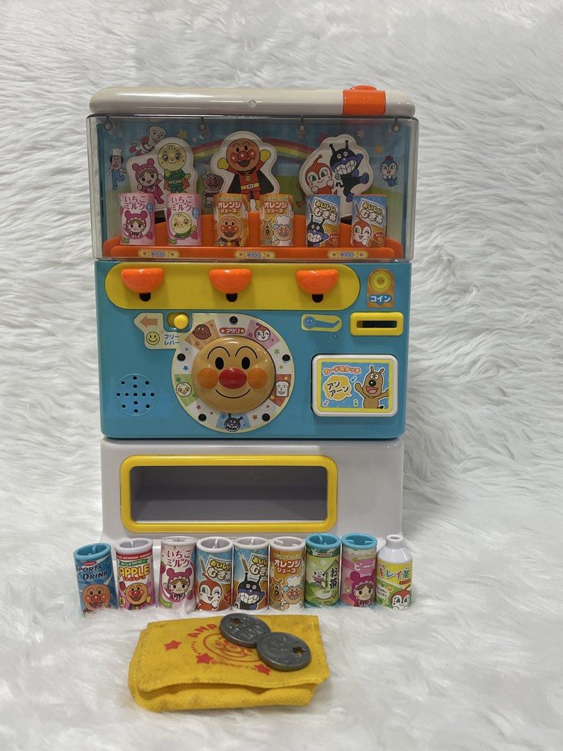 Anpanman Toy Vending Machine With Drinks and Coins (Category: Designer & Blind Box Toys) located in Cavite. Submitted by kobebean_122 (Listing ID 1468634158, Image 1). Description: - Interactive Anpanman vending machine toy for fun pretend play - Features cute character buttons, spinning Anpanman dial, and a working coin slot - Top pushes open easily to restock drinks - Includes 10 miniature drink cans - Comes with 2 play coins and a matching yel