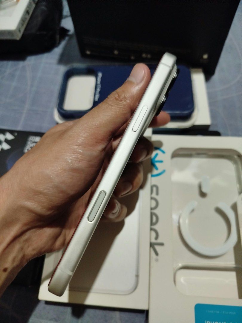 Apple iPhone Pro Max Silver with Phone Cases and Accessories (Category: iPhone 17 Series) located in Makati City. Submitted by caloy1017 (Listing ID 1468692656, Image 3). Description: - Model: Silver iPhone Pro Max in pristine, scratch-free condition (front and back) - Condition: Clean body with fully functional buttons, USB-C port, and triple camera setup - Inclusions: Beyond the Box paper bag, dark blue phone case, Speck MagSafe case packaging,