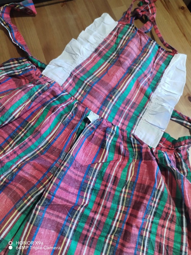 Apron (Category: Towels, Napkins & Holders) located in Muntinlupa City. Submitted by arciagamaryann68 (Listing ID 1468563296, Image 3). Description: - Classic red, green, and blue plaid checkered pattern - Charming white ruffled accents along the sides - Adjustable tie straps for a comfortable fit - Stylish and functional, perfect for cooking, baking, or kitchen vlogging - Good pre-loved condition.
