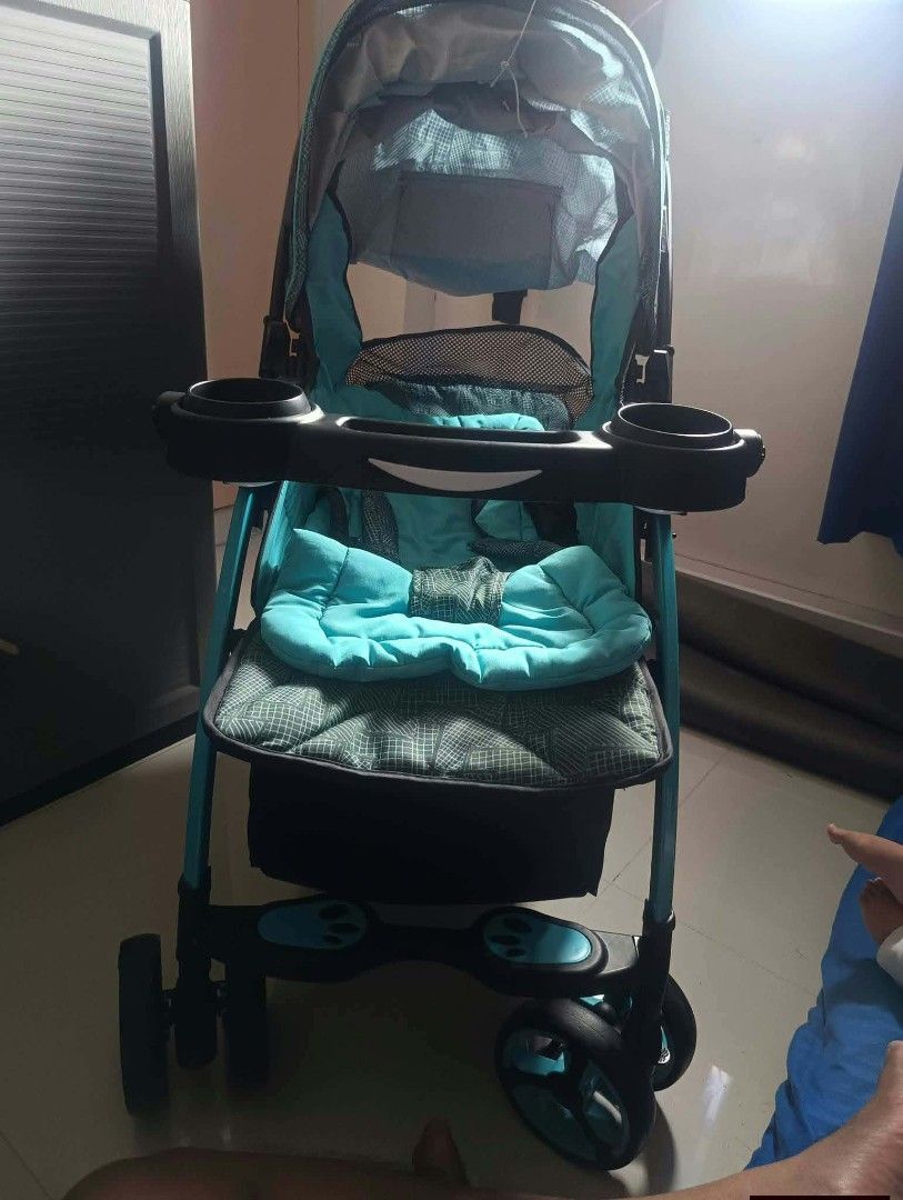 Apruva Baby Stroller Turquoise Blue Black (Category: Strollers) located in Paranaque City. Submitted by bornandbread21 (Listing ID 1468705160, Image 2). Description: - Color: Stylish Turquoise Blue and Black - Comfort & Convenience: Padded seat cushion and full canopy with a mesh window - Child Tray: Includes built-in dual cup holders - Storage: Extra-large under-seat basket for diaper bags and groceries - Mobility: Smooth-rolling wheels ideal fo
