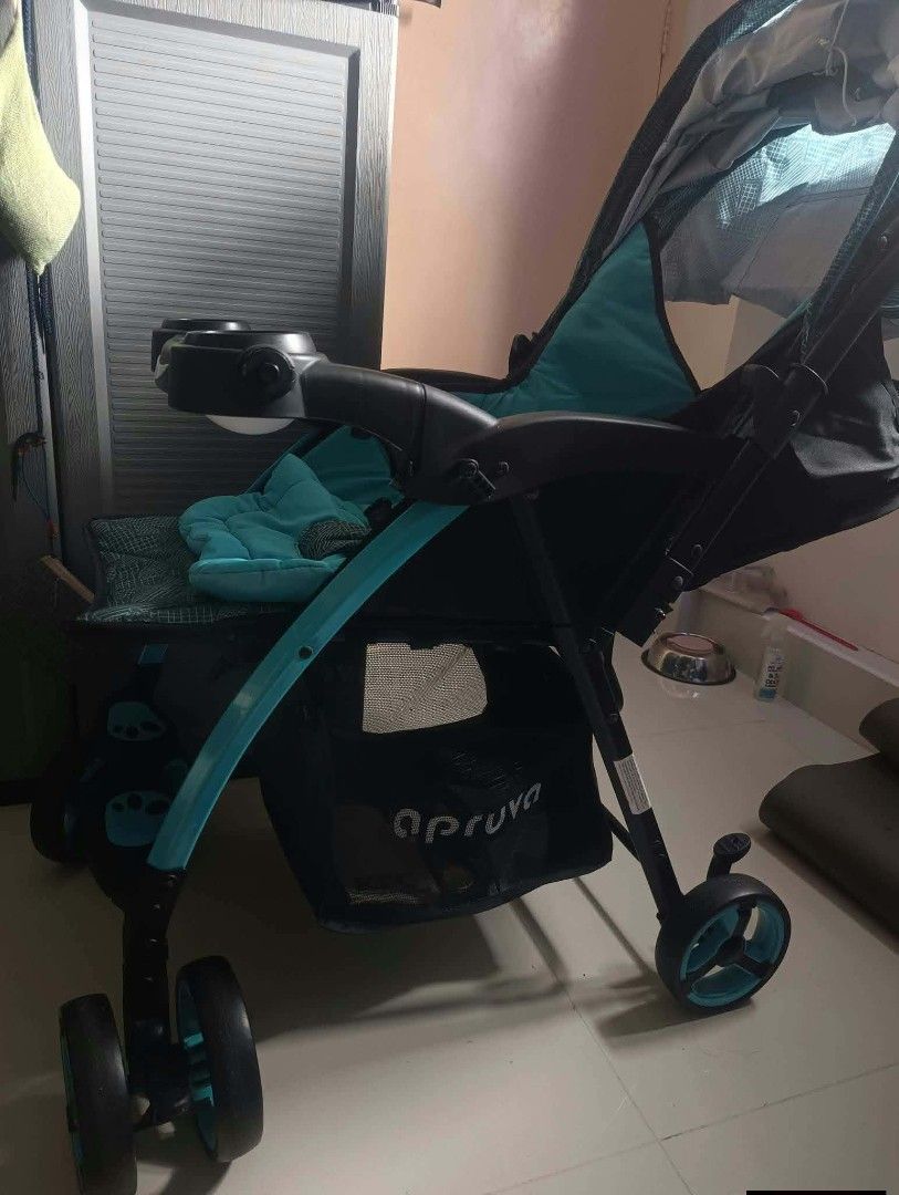Apruva Baby Stroller Turquoise Blue Black (Category: Strollers) located in Paranaque City. Submitted by bornandbread21 (Listing ID 1468705160, Image 3). Description: - Color: Stylish Turquoise Blue and Black - Comfort & Convenience: Padded seat cushion and full canopy with a mesh window - Child Tray: Includes built-in dual cup holders - Storage: Extra-large under-seat basket for diaper bags and groceries - Mobility: Smooth-rolling wheels ideal fo