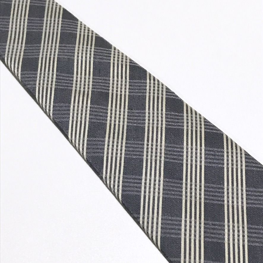 ARALON Plaid Gray Neck Tie (Category: Ties) located in Taguig. Submitted by retrogaze (Listing ID 1468561764, Image 3). Description: This textured necktie by ARALON features a charcoal-grey base woven in a multi-textured twill ground. The blade showcases a geometric bias plaid pattern composed of subtle shadow-checked blocks interwoven with sharp, light cream pinstripe bands. Brand Overview ARALON is a practical Japanese menswear accessories labe