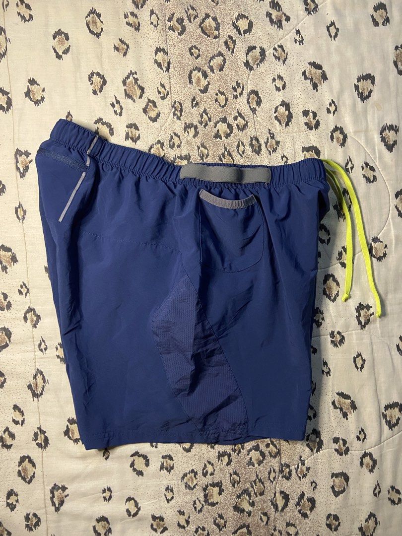Asics Running Shorts Blue with Pockets (Category: Shorts) located in Manila. Submitted by nix.thrift (Listing ID 1468608739, Image 2). Description: - Brand: Asics - Color: Navy blue with neon yellow drawstring - Size: meduim - Storage: Multiple waist drop-in pockets + 1 secure zippered back pocket - Ventilation: Mesh side panels for airflow - Safety: Reflective Asics logo near the hem - Comfort: Built-in inner liner - Material: Polyester blend, e