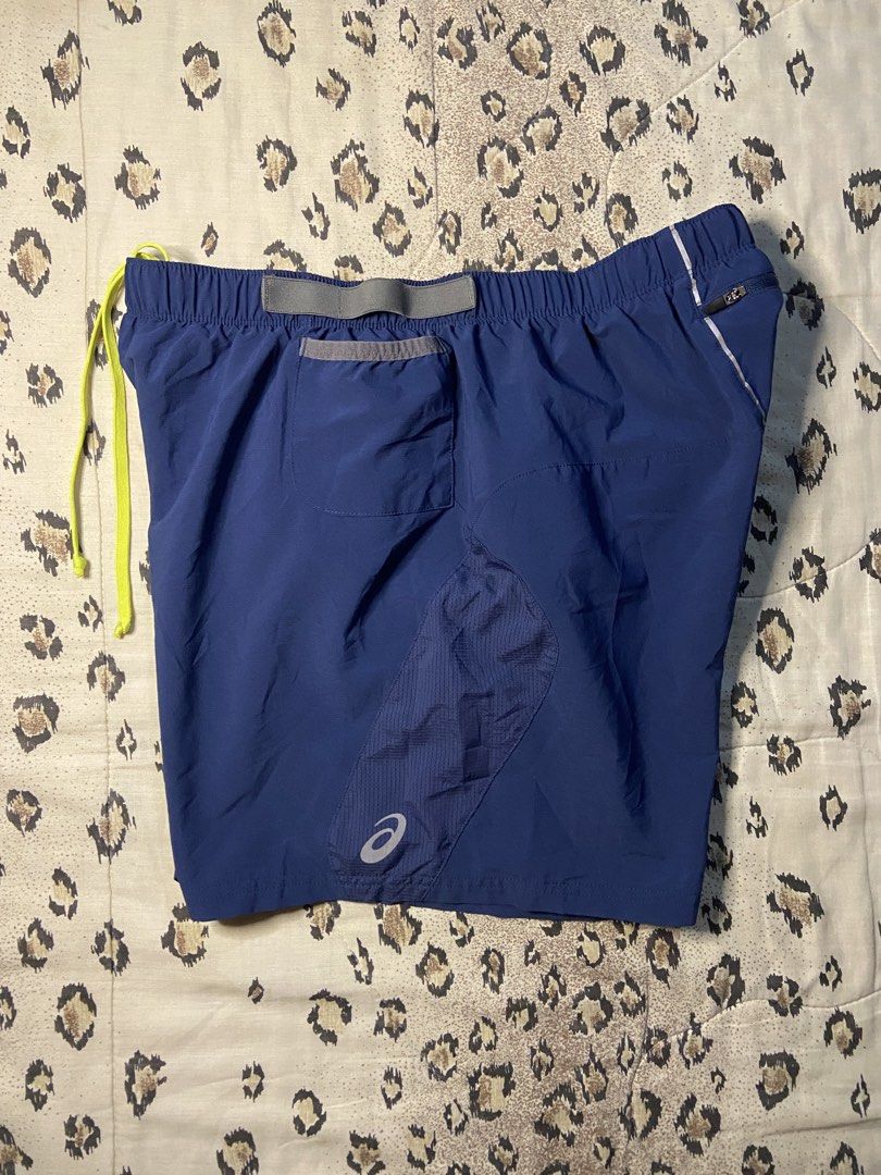 Asics Running Shorts Blue with Pockets (Category: Shorts) located in Manila. Submitted by nix.thrift (Listing ID 1468608739, Image 1). Description: - Brand: Asics - Color: Navy blue with neon yellow drawstring - Size: meduim - Storage: Multiple waist drop-in pockets + 1 secure zippered back pocket - Ventilation: Mesh side panels for airflow - Safety: Reflective Asics logo near the hem - Comfort: Built-in inner liner - Material: Polyester blend, e