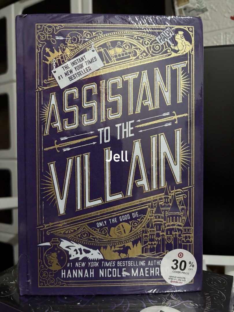 Assistant to the Villain Special Edition (Category: Storybooks) located in Calamba. Submitted by jeLLaaax (Listing ID 1468603747, Image 1). Description: - Title: Assistant to the Villain by Hannah Nicole Maehrer - Edition: Hardcover Special Edition - Features: Stunning purple sprayed edges with sword design - Condition: Brand new, unopened, still in original plastic shrink wrap - Note: Includes Target sticker on the front cover - Perfect for coll