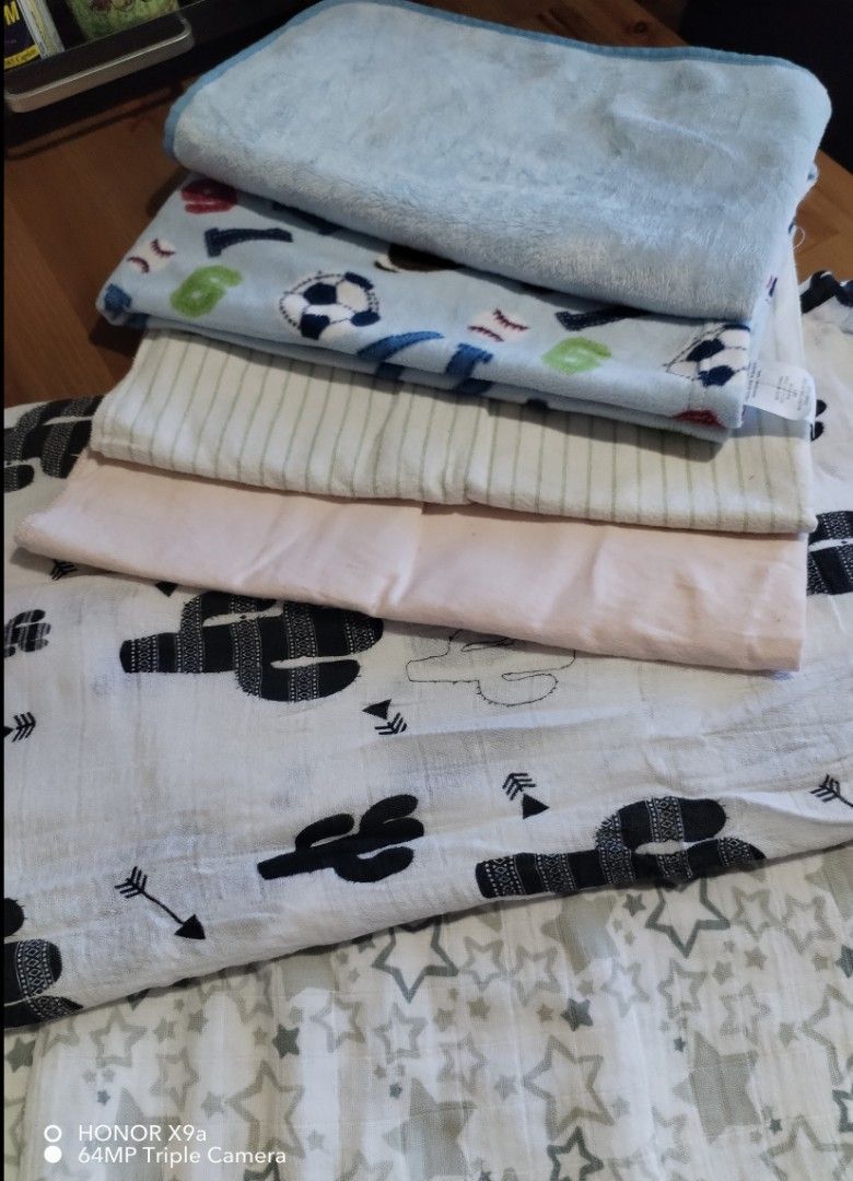 Assorted Baby blankets (Category: Other Baby Bathing & Changing Needs) located in Muntinlupa City. Submitted by arciagamaryann68 (Listing ID 1468595631, Image 2). Description: - Assorted set of baby blankets and swaddles - Features various cute patterns including cacti, stars, sports balls, and stripes - Includes soft plush and breathable cotton-like fabrics - Selected items feature Carter's branding - Excellent pre-loved condition, clean and wel