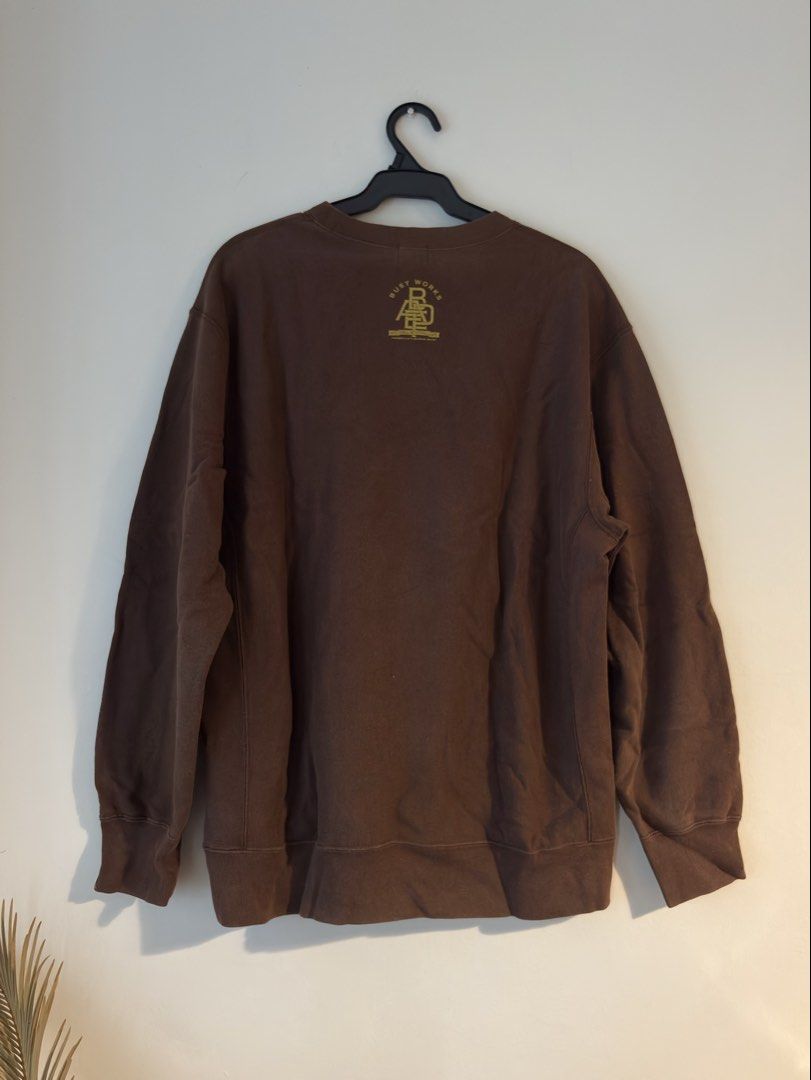Authentic A Bathing Ape (BAPE) Crewneck Sweatshirt (Category: Luxury Apparel) located in Mandaluyong City. Submitted by material_boi (Listing ID 1468580924, Image 2). Description: Store bought in Japan years ago. Not ukay or thrifted kaya sure legit. 100% cotton. Made in Japan. Choco brown ang color. Makapal. Malambot. The print is literal gold, parang foil. Size is L and runs 22.5 inches wide and 29 inches long. No issues, just signs of wash and