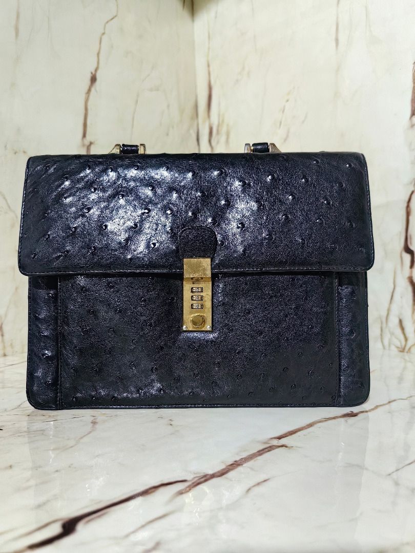 Authentic Black Ostrich Leather Briefcase with Combination Lock (Category: Briefcases) located in Tarlac. Submitted by jeremiah.curator.2026 (Listing ID 1468527756, Image 1). Description: - Authentic black ostrich leather briefcase with distinct quill follicle pattern - Structured silhouette featuring a secure flap closure - Elegant gold-tone combination lock mechanism on the front clasp - Sturdy, reinforced top handle with durable metallic hardw