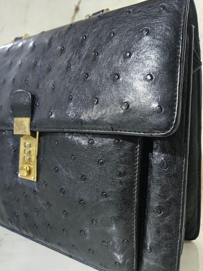 Authentic Black Ostrich Leather Briefcase with Combination Lock (Category: Briefcases) located in Tarlac. Submitted by jeremiah.curator.2026 (Listing ID 1468527756, Image 2). Description: - Authentic black ostrich leather briefcase with distinct quill follicle pattern - Structured silhouette featuring a secure flap closure - Elegant gold-tone combination lock mechanism on the front clasp - Sturdy, reinforced top handle with durable metallic hardw