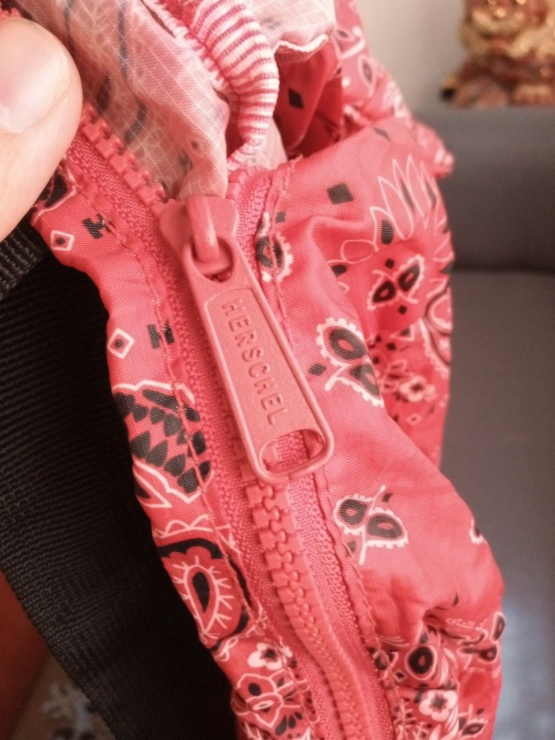 Authentic Herschel Supply Co. Red Bandana Packable Backpack (Category: Backpacks) located in General Trias. Submitted by dwyane09 (Listing ID 1468551319, Image 3). Description: - Brand: Herschel Supply Co. - Design: Eye-catching red bandana print with classic woven label - Feature: Packable design folds right into its own internal pocket - Material: Lightweight, durable nylon with comfortable black straps - Pockets: Convenient front zippered pock