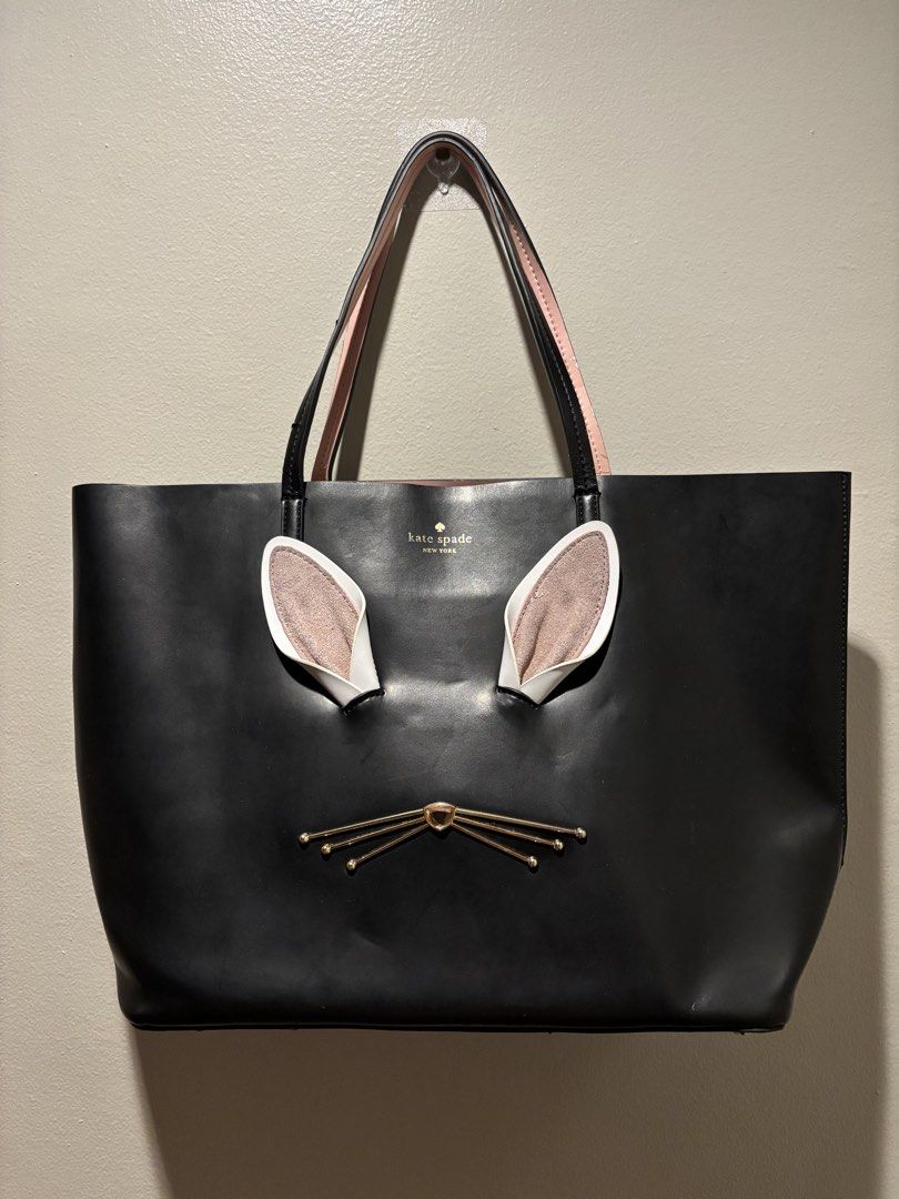 Authentic Kate Spade Large Tote (Category: Luxury Bags & Wallets) located in Manila. Submitted by eliteinme (Listing ID 1468666886, Image 1). Description: With minor flaws as shown but still very nice. Collection: Kate Spade Make Magic Collection Model Name: Make Magic Rabbit Hallie Leather Tote Material: Smooth black crosshatched/refined leather with suede-lined interior ears and gold-tone metallic whisker hardware. Colorway: Black with soft pin
