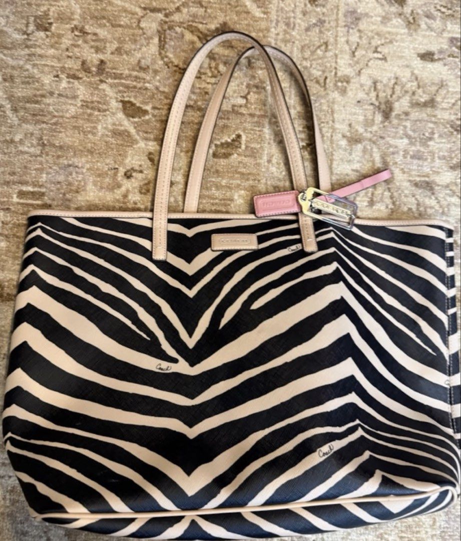 🇺🇸 Authentic Rare Coach Zebra Print Tote Bag (Category: Luxury Bags & Wallets) located in Manila. Submitted by prelovedpick.com (Listing ID 1468308683, Image 1). Description: DECLUTTERING ‼️ FIXED PRICE WITH FREEBIES - Authentic Coach tote bag (Style: F26983) - Eye-catching zebra print pattern with beige leather trim and handles - Roomy interior with fabric lining and secure zip pocket - Includes signature metallic Coach hangtag - Comes with ha