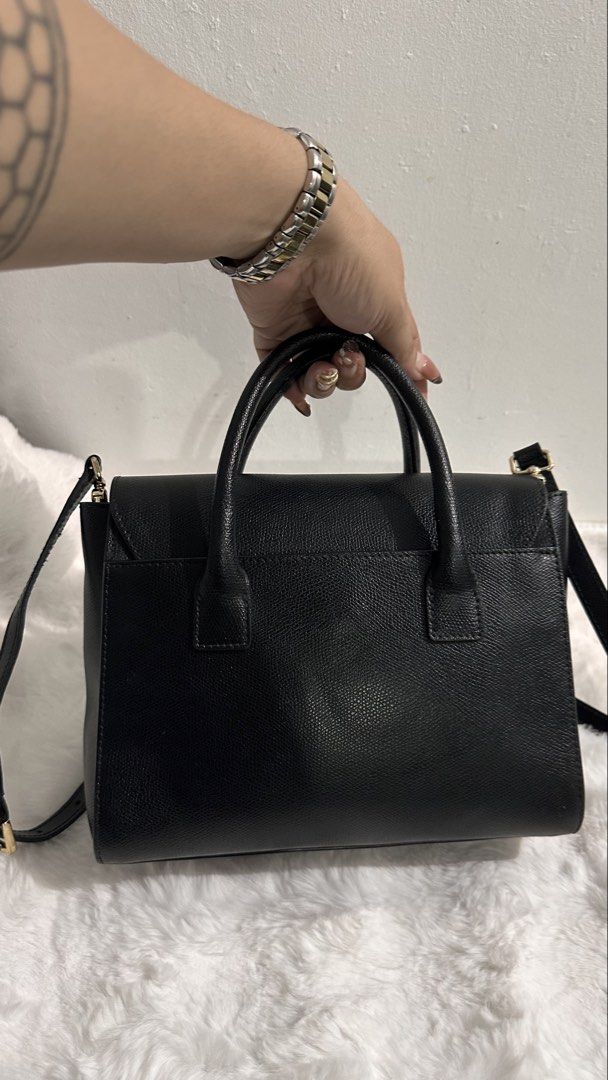💯Authentic/Original Furla Metropolis Small Satchel Bag (Category: Luxury Bags & Wallets) located in Las Pinas. Submitted by allenscloset (Listing ID 1468624969, Image 2). Description: Minimal fading hardwares Brand: Furla Condition: Good Source: Japan Origin: Italy Style: Structured satchel / top-handle bag Color: Black with gold-tone metal hardware Features: Two rounded top handles, a front flap with a branded metal clasp, and a long shoulder s