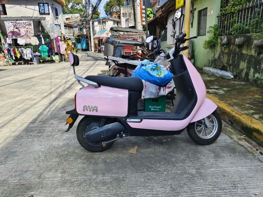 AYA Pink Electric Scooter (Category: Skates, Rollerblades & Scooters) located in Manila. Submitted by zenhawk_2d3bf2 (Listing ID 1468636053, Image 1). Description: - Color: Eye-catching pink with sleek black accents - Comfort: Includes an attached passenger backrest and easy step-through frame design - Wheels: Premium silver alloy wheels - Type: Electric scooter, ideal for street riding and daily commutes.