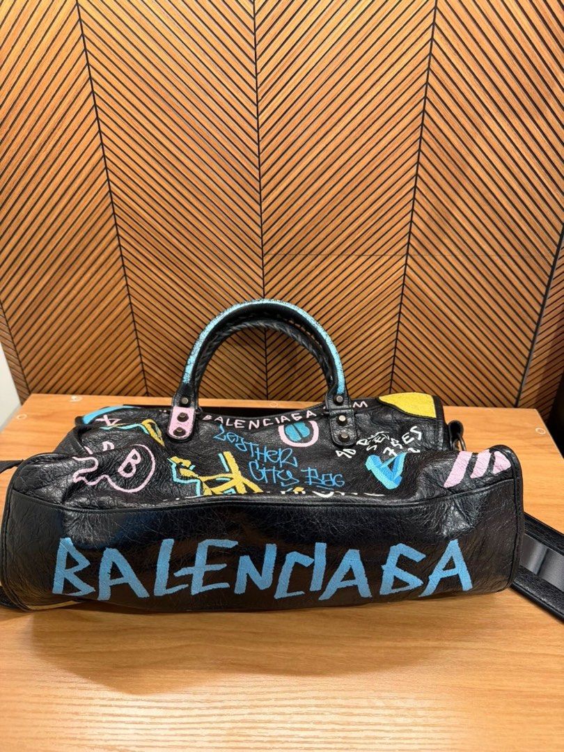 Balenciaga graffiti city bag (Category: Luxury Bags & Wallets) located in Carmona. Submitted by beajuan (Listing ID 1468562104, Image 3). Description: Guaranteed Authentic Balenciaga city bag in graffiti black arena Convertible to Crossbody and shoulder No major flaw Rated 9/10 condition from IG shop (consignment) Actual photos are posted Can do meet up at Carmona/Binan.