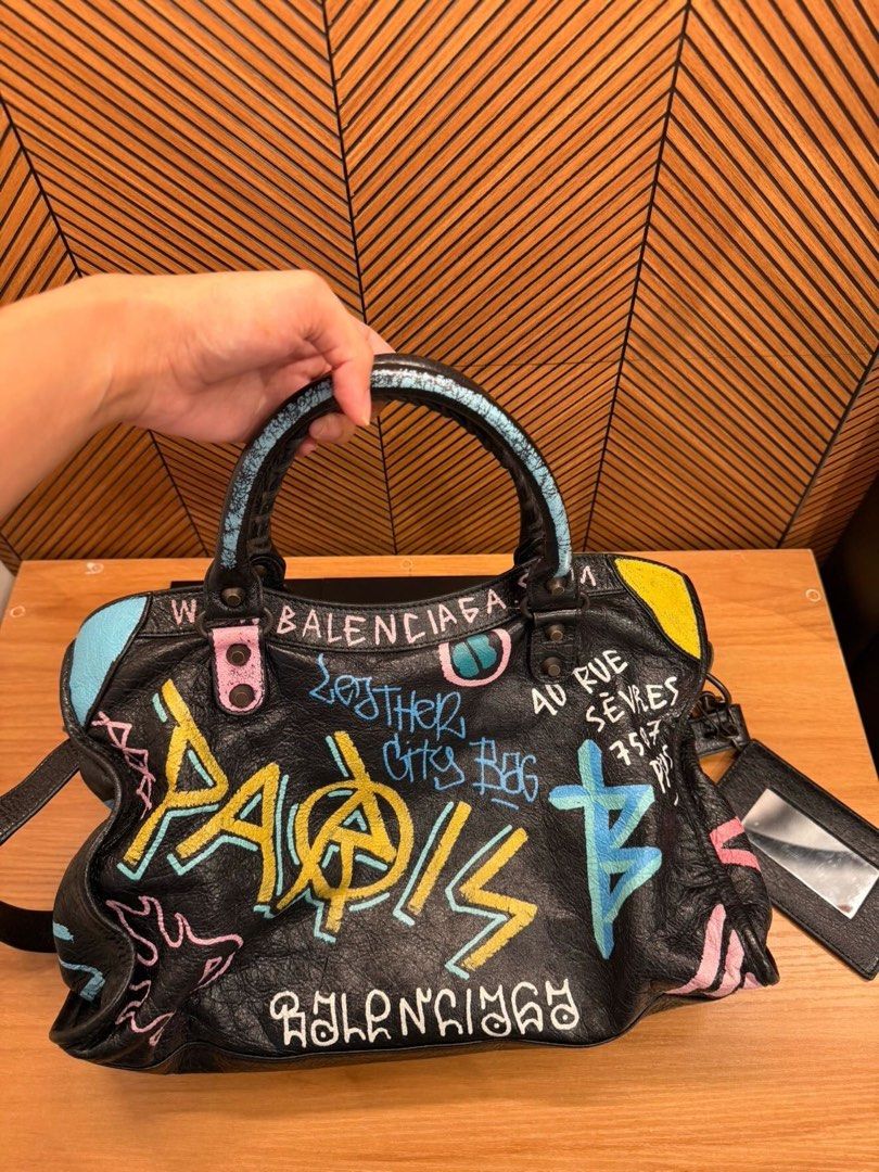 Balenciaga graffiti city bag (Category: Luxury Bags & Wallets) located in Carmona. Submitted by beajuan (Listing ID 1468562104, Image 2). Description: Guaranteed Authentic Balenciaga city bag in graffiti black arena Convertible to Crossbody and shoulder No major flaw Rated 9/10 condition from IG shop (consignment) Actual photos are posted Can do meet up at Carmona/Binan.