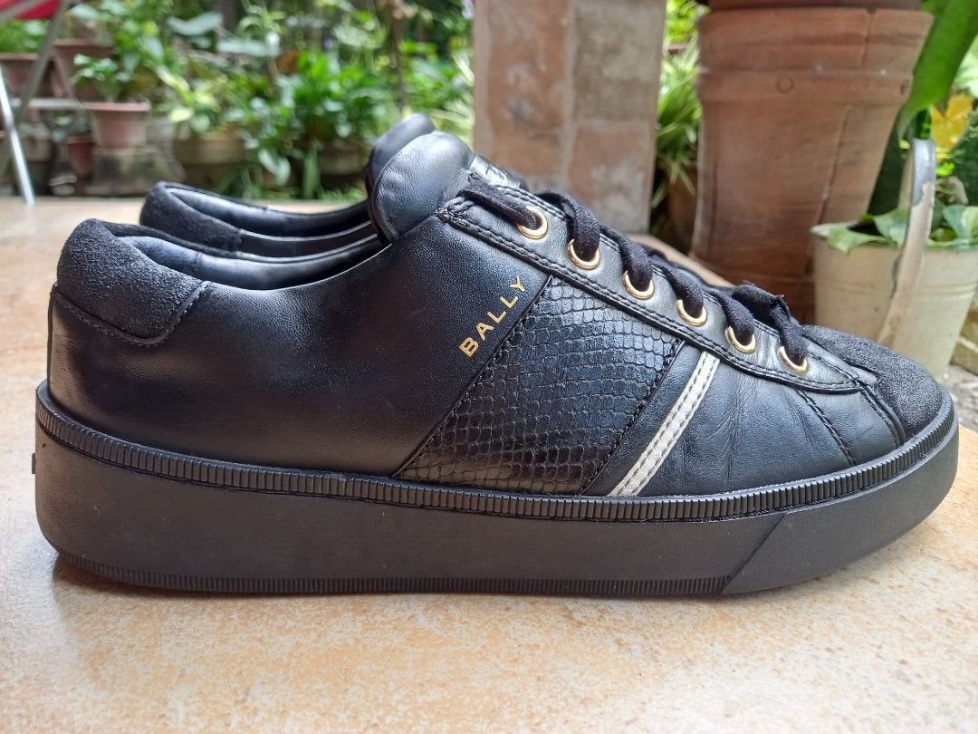 Bally Black Leather Sneaker Platform Shoes (Category: Sneakers) located in Davao. Submitted by kirk214red-50020 (Listing ID 1468552041, Image 3). Description: Bally black leather sneakers with textured snakeskin side panel and gold-tone eyelets. Chunky black rubber platform sole. Suede detail at the toe and heel counter. Gold Bally logo stamped on the side and embossed on the heel sole. Lace-up closure with flat black laces..