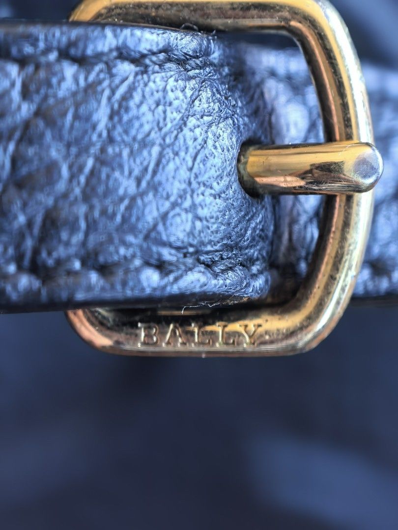 Bally Leather Crossbody Bag (Category: Luxury Bags & Wallets) located in Cagayan de Oro. Submitted by tommygurl1218 (Listing ID 1468506289, Image 2). Description: - Brand: Bally Switzerland (Made in Italy) - Material: Premium black pebbled leather with textured dark red interior lining - Design: Large embossed 'B' letter on the front flap - Hardware: Gold-tone with engraved Bally branding - Strap: Adjustable leather shoulder strap - Condition: Ex