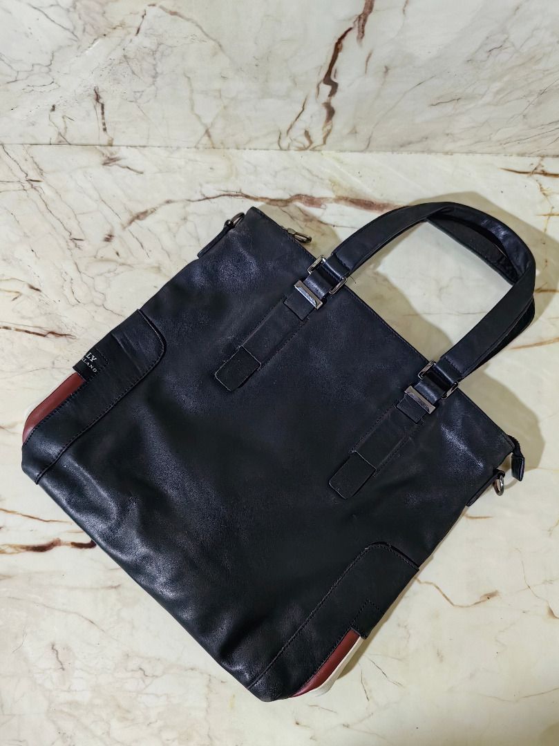 Bally Switzerland Black Tote Bag (Category: Tote Bags) located in Tarlac. Submitted by jeremiah.curator.2026 (Listing ID 1468665563, Image 1). Description: - Authentic black leather Bally Switzerland tote bag - Signature red and white stripe accent on the side panel - Dual top handles for comfortable carrying - Secure silver-tone hardware zip closure - Roomy interior perfect for holding daily essentials - Condition: Shows gentle signs of wear on 