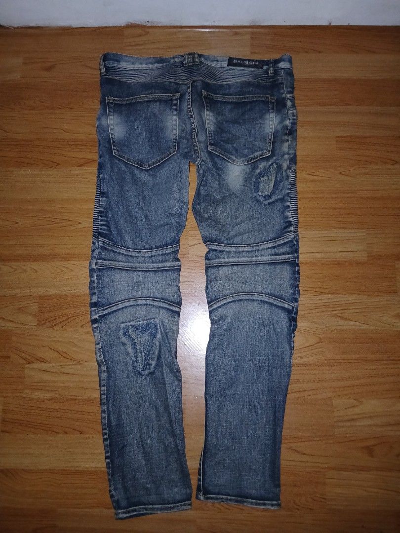 Balmain Biker Distressed Denim Jeans Blue (Category: Jeans) located in General Santos City (Dadiangas). Submitted by afsph1996 (Listing ID 1468562178, Image 3). Description: - Brand: Balmain -Size 34-36 -Length 39 -‼️‼️ issue see last 2 picture - Style: Slim-cut biker jeans in blue denim - Details: Ribbed panels at knees and waist, distressed spots, and patch accents - Hardware: Zipper pockets near waistband and heavy Balmain-branded fly zipper -