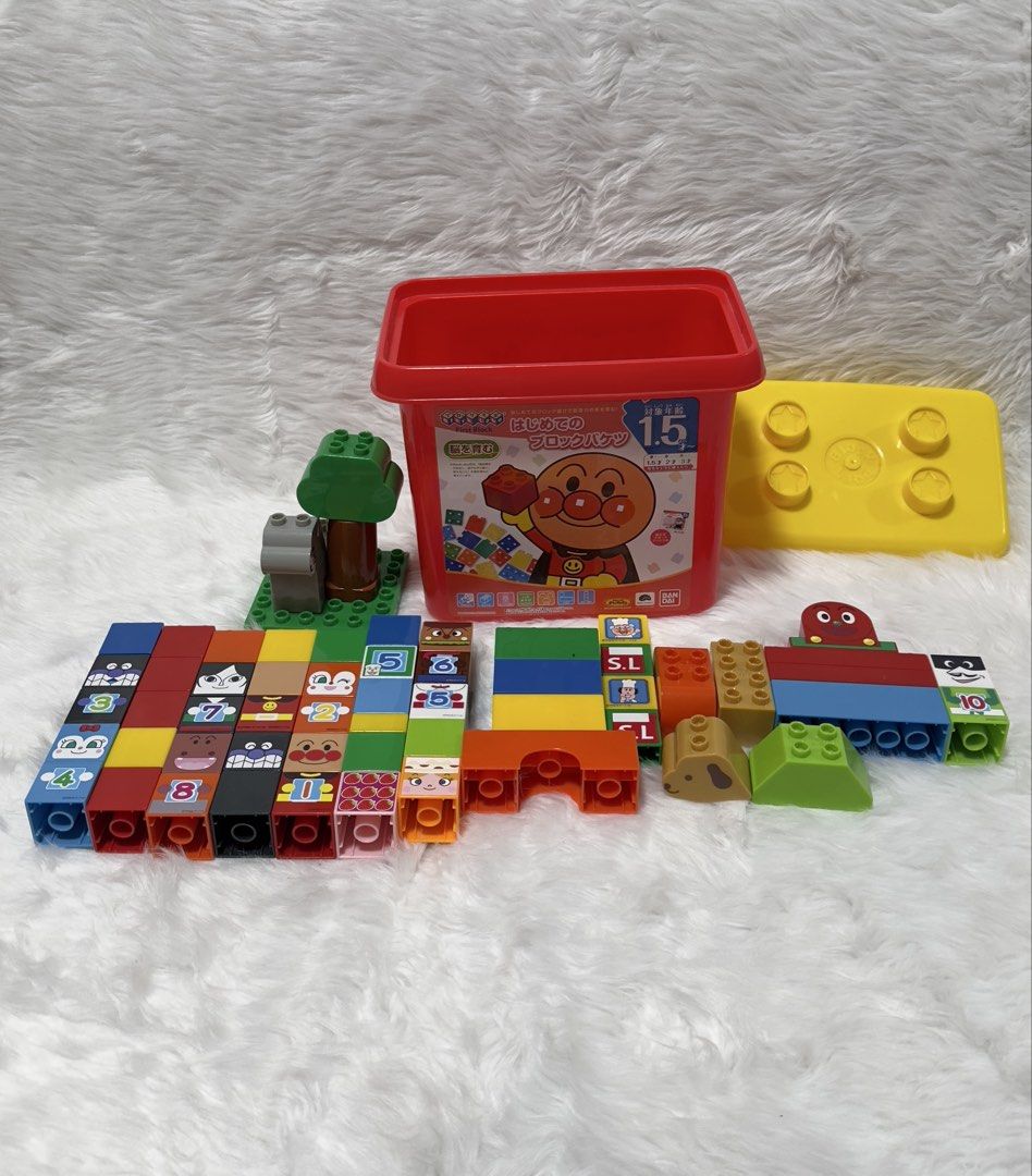 Bandai BlockLabo Anpanman First Block Bucket (Category: Lego & Building Sets) located in Cavite. Submitted by kobebean_122 (Listing ID 1468634256, Image 2). Description: - Authentic Bandai BlockLabo Anpanman building blocks - Comes in a sturdy red storage bucket with a bright yellow lid for easy cleanup - Features colorful, chunky blocks with numbers and beloved character faces - Includes fun tree structures, animal figures, and versatile buildin