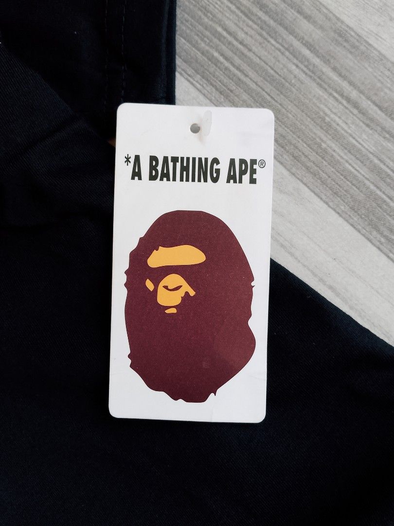 BAPE A Rising Bape Sunset Graphic Tee Black (Category: Tshirts & Polo Shirts ) located in Batangas. Submitted by rafstaywitstaff_11 (Listing ID 1468585107, Image 3). Description: - Brand: A Bathing Ape (BAPE) - Color: Black - Style: Short sleeve t-shirt - Design: Large sunset beach graphic inside signature ape head with 'A Rising Bape' text - Details: Small ape head logo tag on left sleeve hem - Condition: Brand new with hang tag attached.