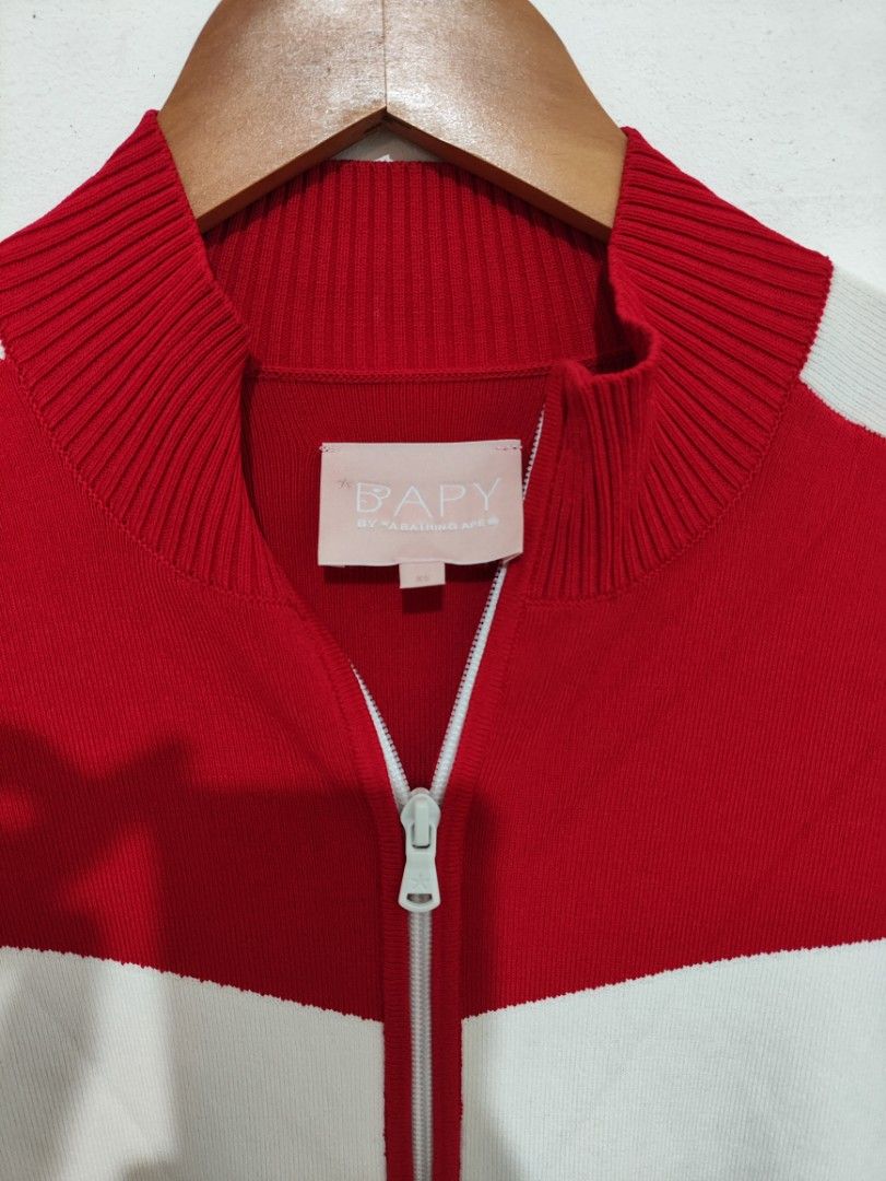 BAPY by A Bathing Ape Red White Zip Jacket (Category: Coats, Jackets and Outerwear) located in Puerto Princesa. Submitted by johnareis162386 (Listing ID 1468587820, Image 2). Description: - Brand: BAPY by A Bathing Ape - Style: Red and white zip-up jacket with mock neck collar and dual zipper pull - Details: Contrast white chest panels, matching side stripes with embroidered lettering, and ribbed cuffs/hem - Size: XS (tag on inner collar) - Mater