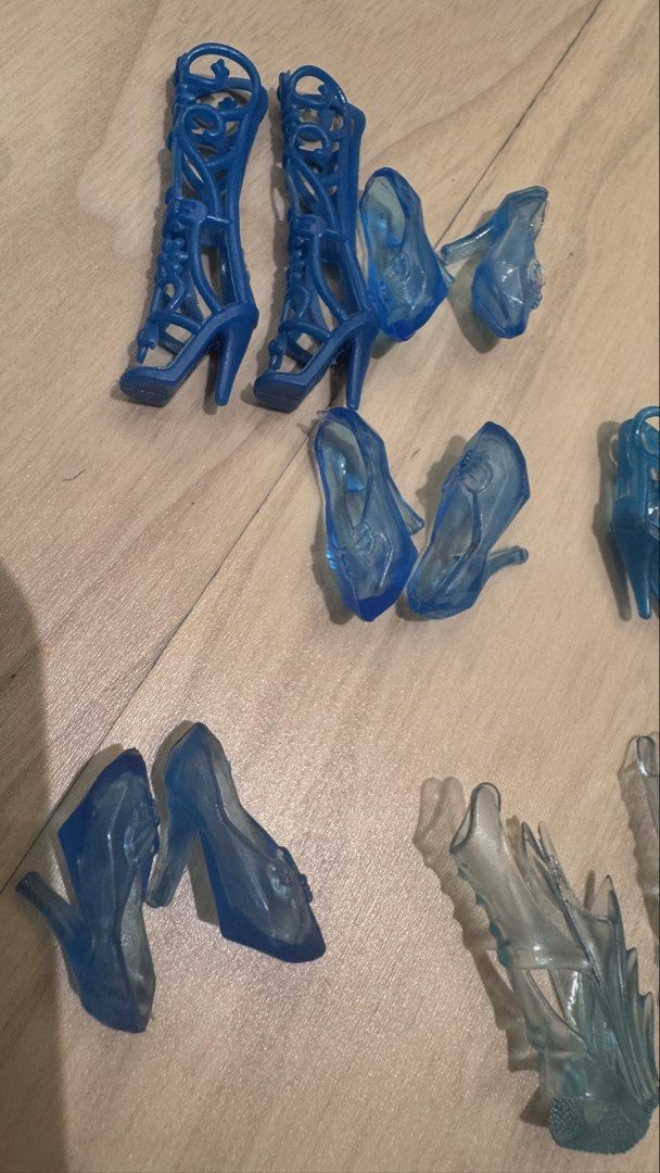 Barbie Assorted Blue Doll Shoes (Category: Kids Toys) located in Mandaluyong City. Submitted by maelovestoshop (Listing ID 1468690752, Image 3). Description: - Assorted blue doll shoes lot in various shades and translucent light blue - Fits standard fashion dolls like Barbie - Includes a variety of styles: heels, knee-high lace-up boots, pointed pumps, strappy sandals, and flats - Great for mixing and matching outfits or replacing missing accesso