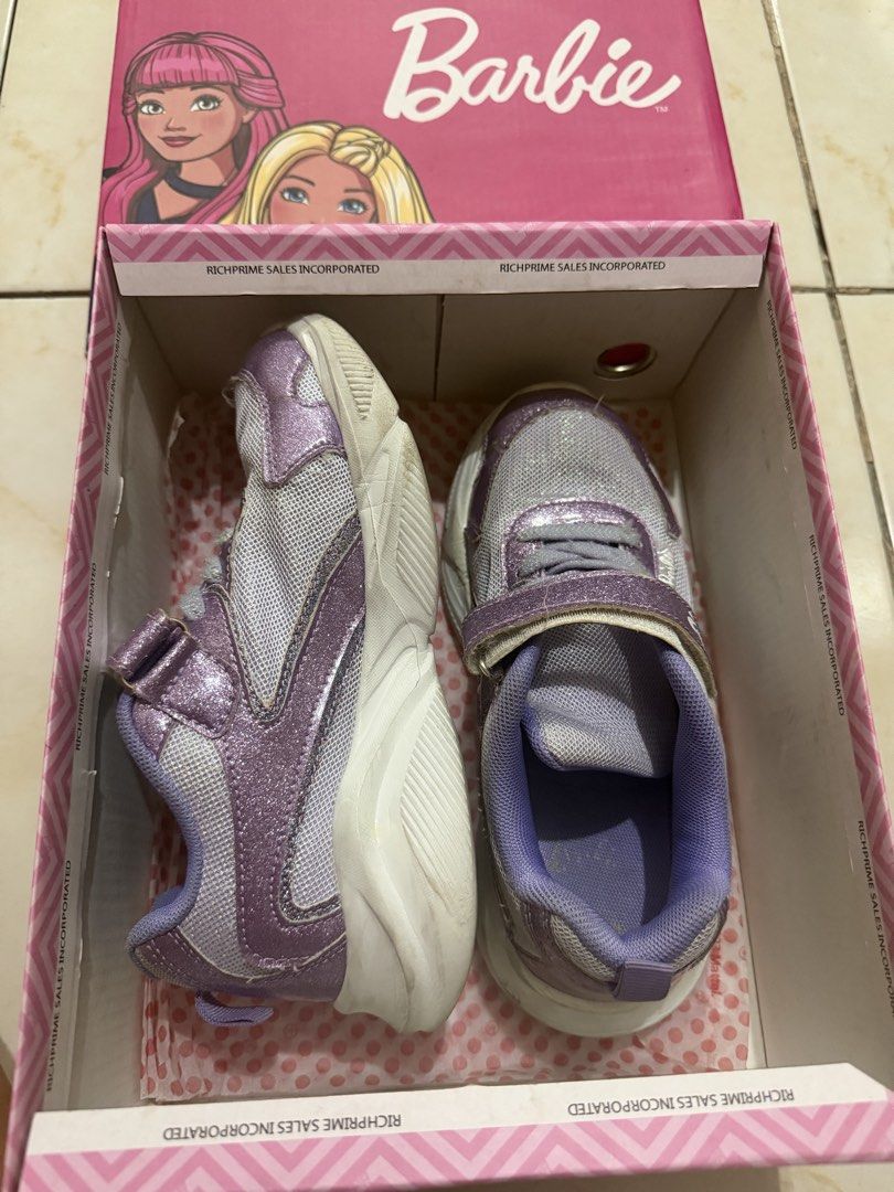 Barbie Dana Lavender Sneakers Size 2 (Category: Sneakers) located in Taguig. Submitted by heideewatts (Listing ID 1468626564, Image 3). Description: - Brand/Model: Barbie Dana Sneakers - Color: Lavender with sparkly glitter finish and white mesh panels - Size: Size 2 (approx. 21 to 24cm sole length) - Features: Chunky white sole, secure velcro strap closure over laces - Inclusion: Original pink Barbie shoebox - Condition: Gently worn with minimal