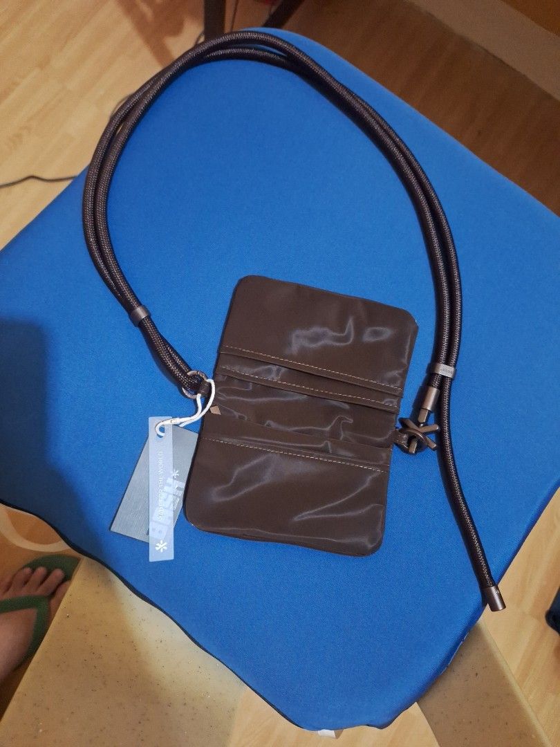 BASH mini cache wallet in terra (Category: Cross-body Bags) located in Caloocan City. Submitted by _mie3 (Listing ID 1468686797, Image 2). Description: - Brand: BASH - Condition: Brand new with original tag - Color: Terra - Material: Shiny nylon-like fabric - Strap: Long rope strap with logo accents - Closure: Magnetic or fold-over design - Perfect for keeping cards, cash, and small essentials secure while on the go.