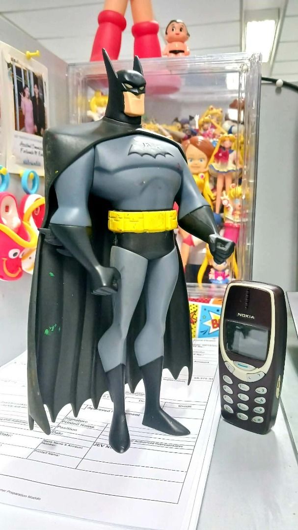 BATMAN 11inches Animated Series (Category: Vintage Collectibles) located in Manila. Submitted by mickey_salonga (Listing ID 1468606813, Image 1). Description: - DC Animated Series Batman action figure - Classic gray and black suit with yellow utility belt - Stands upright on its own - Cape attached at the shoulders - Perfect nostalgic piece for collectors - Note: Nokia phone in photo is for scale only.