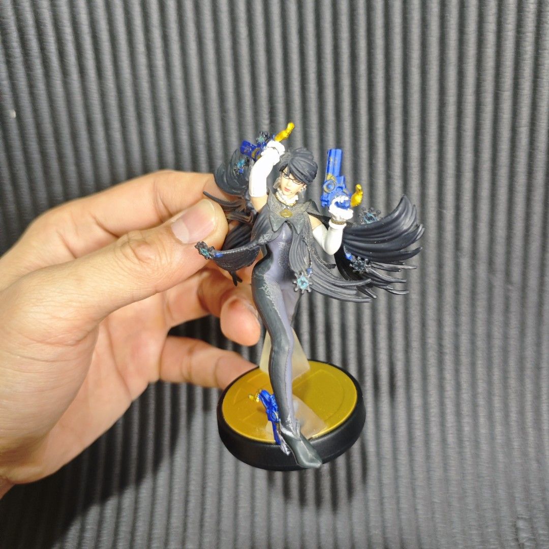 Bayonetta (Player 2) amiibo (Category: In-Game Products) located in Quezon City. Submitted by shopme_gadget30 (Listing ID 1468546015, Image 1). Description: • Character: Bayonetta (Cereza in her short-haired, gray-and-blue Bayonetta 2 outfit) • Series: Nintendo Super Smash Bros. Amiibo Collection (Player 2 variant) • Compatibility: Can be scanned using NFC on the Nintendo Switch, Nintendo 3DS, or Wii U to unlock in-game features and data storage.