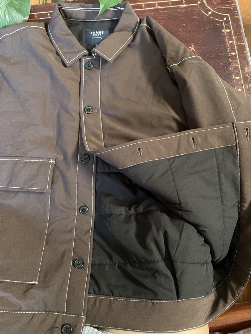 BEAMS HEART Brown Quilted Jacket (Category: Coats, Jackets and Outerwear) located in Manila. Submitted by barrybalenshagga (Listing ID 1468642542, Image 2). Description: - Brand: BEAMS HEART - Size: Small - Color: Dark brown with contrast white stitching - Lining: Quilted black lining - Closure: Button-up front - Pockets: Two large front patch pockets - Condition: Clean, versatile everyday layering piece.