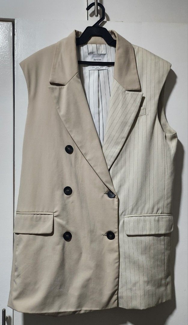 Bershka 2Tailored Half Pinstripe Half Solid Beige Double Breasted Vest (Category: Sleeveless) located in Taytay. Submitted by luxebagcray (Listing ID 1468597534, Image 1). Description: - Brand: Bershka - Size: S - Origin: Made in Turkey - Design: Unique half-solid beige and half-pinstripe style - Details: Double-breasted front with dark buttons, two front pockets, fully lined interior - Styling: Perfect statement piece for layering over plain shi