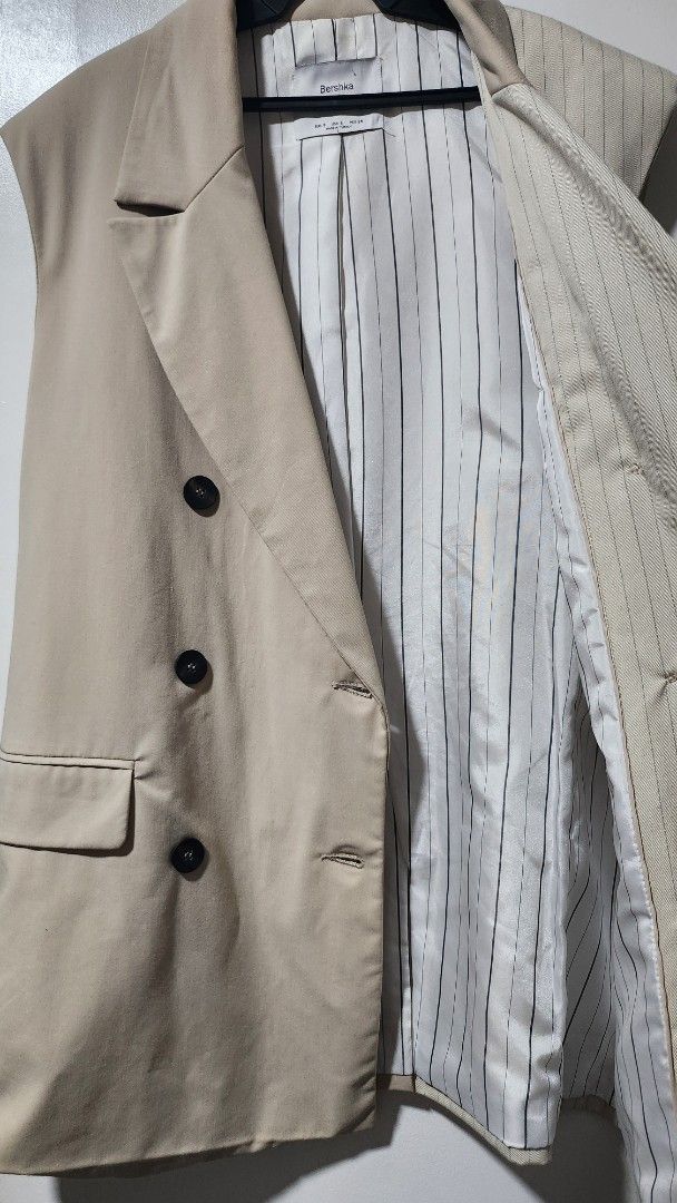 Bershka 2Tailored Half Pinstripe Half Solid Beige Double Breasted Vest (Category: Sleeveless) located in Taytay. Submitted by luxebagcray (Listing ID 1468597534, Image 3). Description: - Brand: Bershka - Size: S - Origin: Made in Turkey - Design: Unique half-solid beige and half-pinstripe style - Details: Double-breasted front with dark buttons, two front pockets, fully lined interior - Styling: Perfect statement piece for layering over plain shi