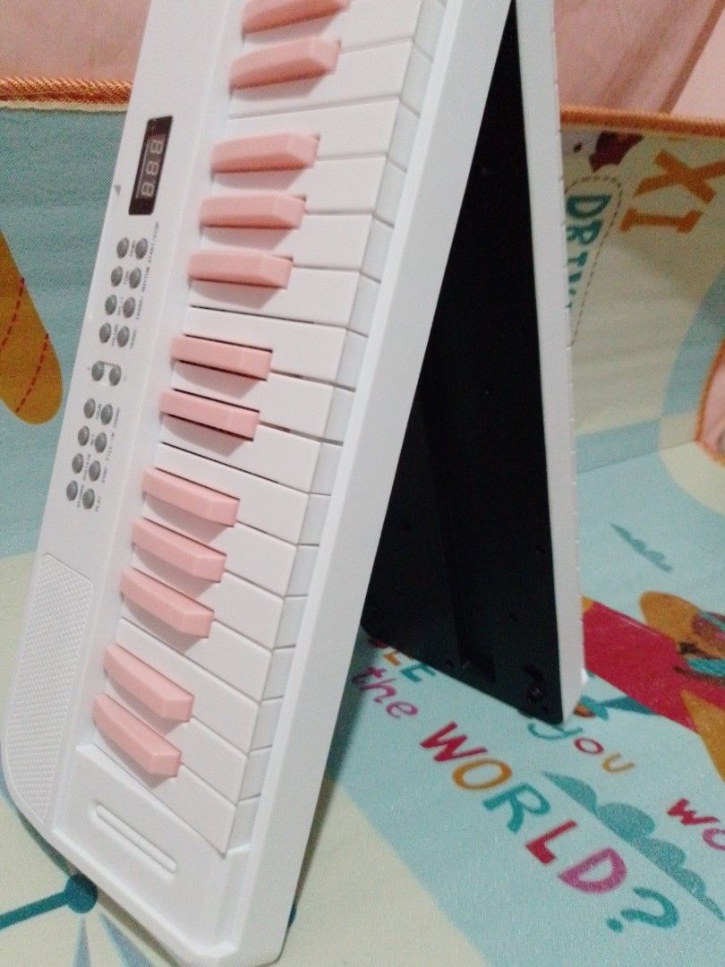 BETSY Roll Up Electronic Piano Keyboard White Pink (Category: Musical Instruments) located in Manila. Submitted by shanscrft (Listing ID 1468634411, Image 2). Description: - Brand: BETSY Portable Electronic Keyboard - Color: White body with adorable pink keys - Design: Foldable in half for easy storage and travel - Features: Digital display screen, built-in speaker, and control buttons for tone, volume, demo, rhythm, and record functions - Ideal 