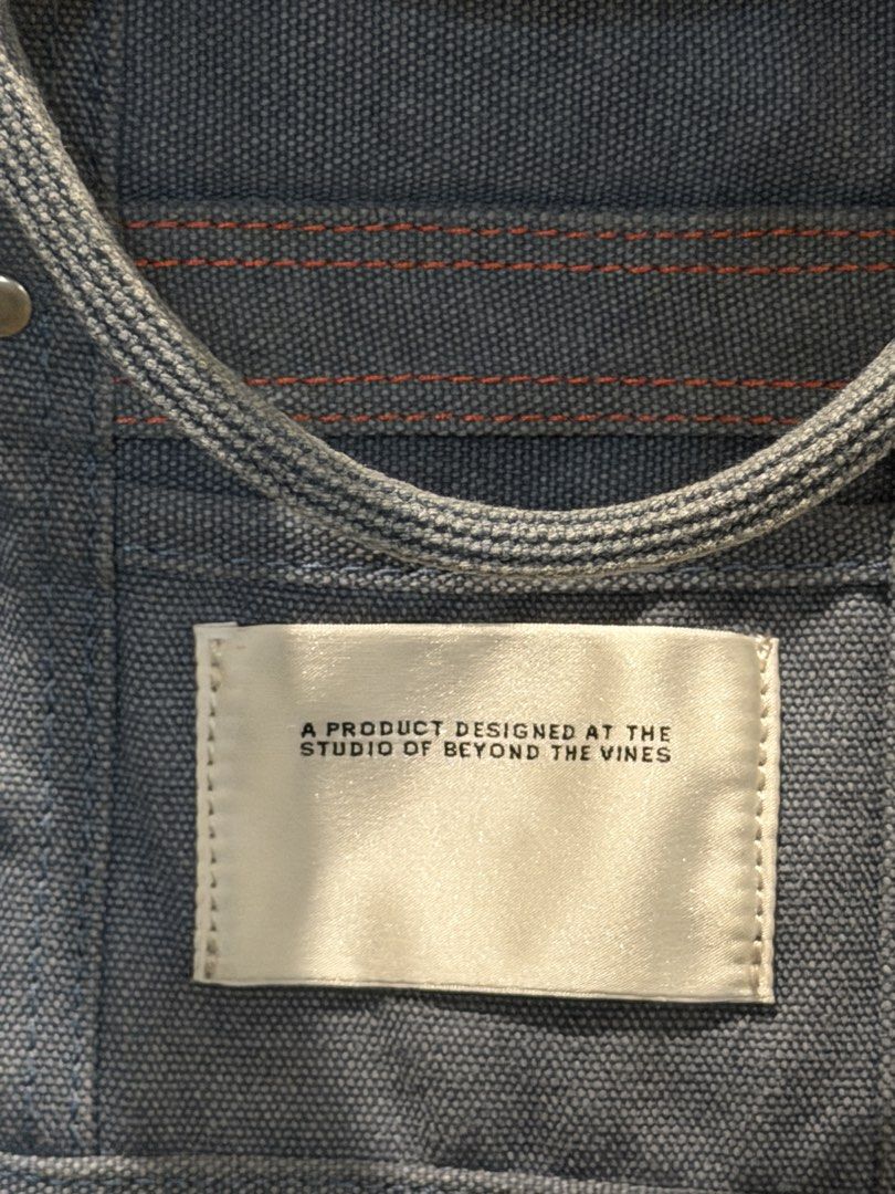 Beyond The Vines Canvas Carryall 01 (Category: Tote Bags) located in Manila. Submitted by db_collective (Listing ID 1468503970, Image 2). Description: - Brand: Beyond The Vines - Style: Canvas Carryall (first edition) - Color: Indigo - Dimensions: 9.5" x 12.5" x 3.5" - Features sturdy top handles and an adjustable shoulder strap, snap closure - Designed with a signature front fabric label - Durable everyday bag that gets better with time.