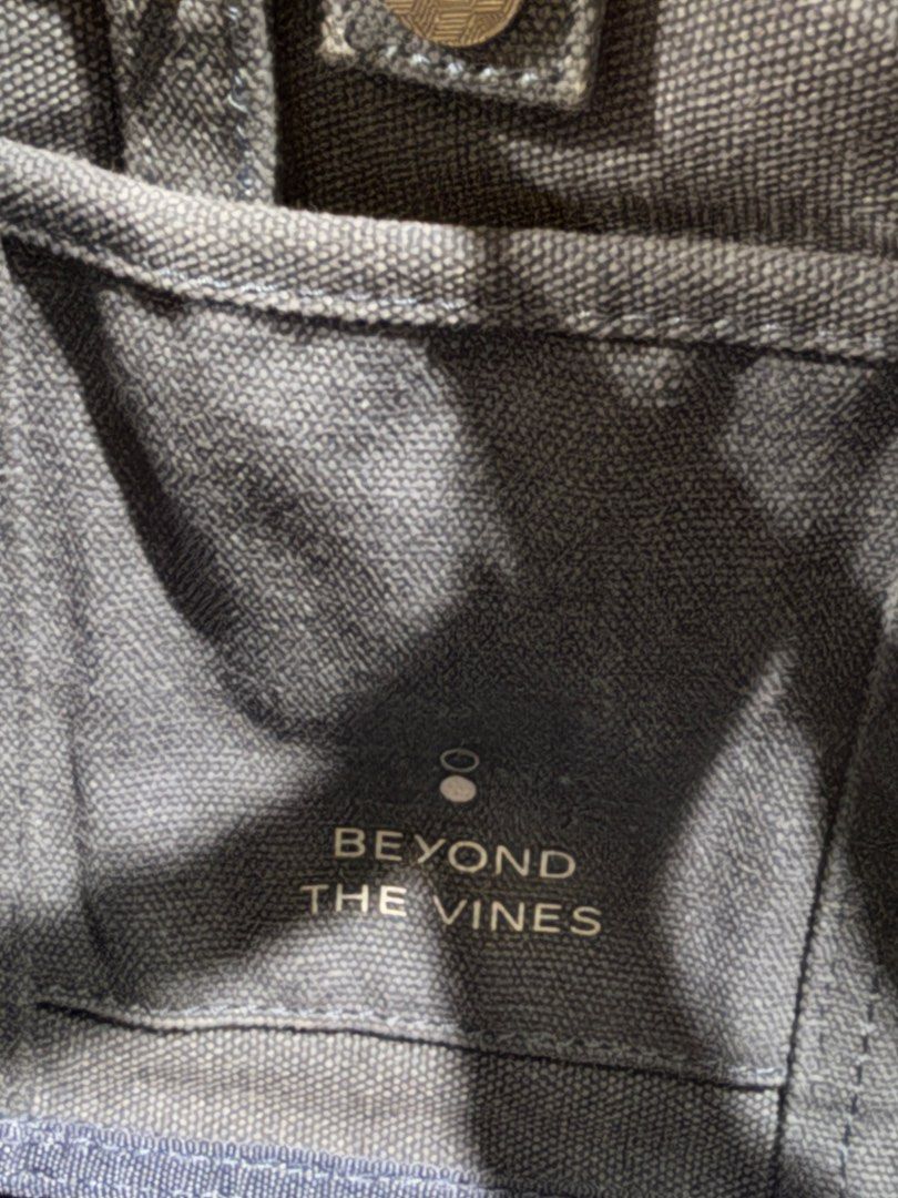 Beyond The Vines Canvas Carryall 01 (Category: Tote Bags) located in Manila. Submitted by db_collective (Listing ID 1468503970, Image 3). Description: - Brand: Beyond The Vines - Style: Canvas Carryall (first edition) - Color: Indigo - Dimensions: 9.5" x 12.5" x 3.5" - Features sturdy top handles and an adjustable shoulder strap, snap closure - Designed with a signature front fabric label - Durable everyday bag that gets better with time.