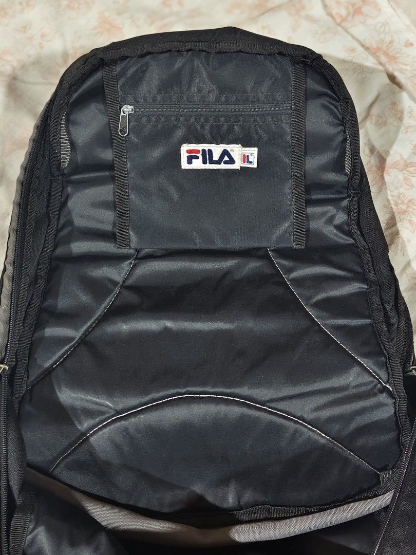 FILA black and gray casual backpack (Category: Backpacks) located in Bulacan. Submitted by angel.decluttersx (Listing ID 1468665047, Image 3). Description: L 17" W 16" all zippers are working no issue please buy at your own risk and manage your expectations.
