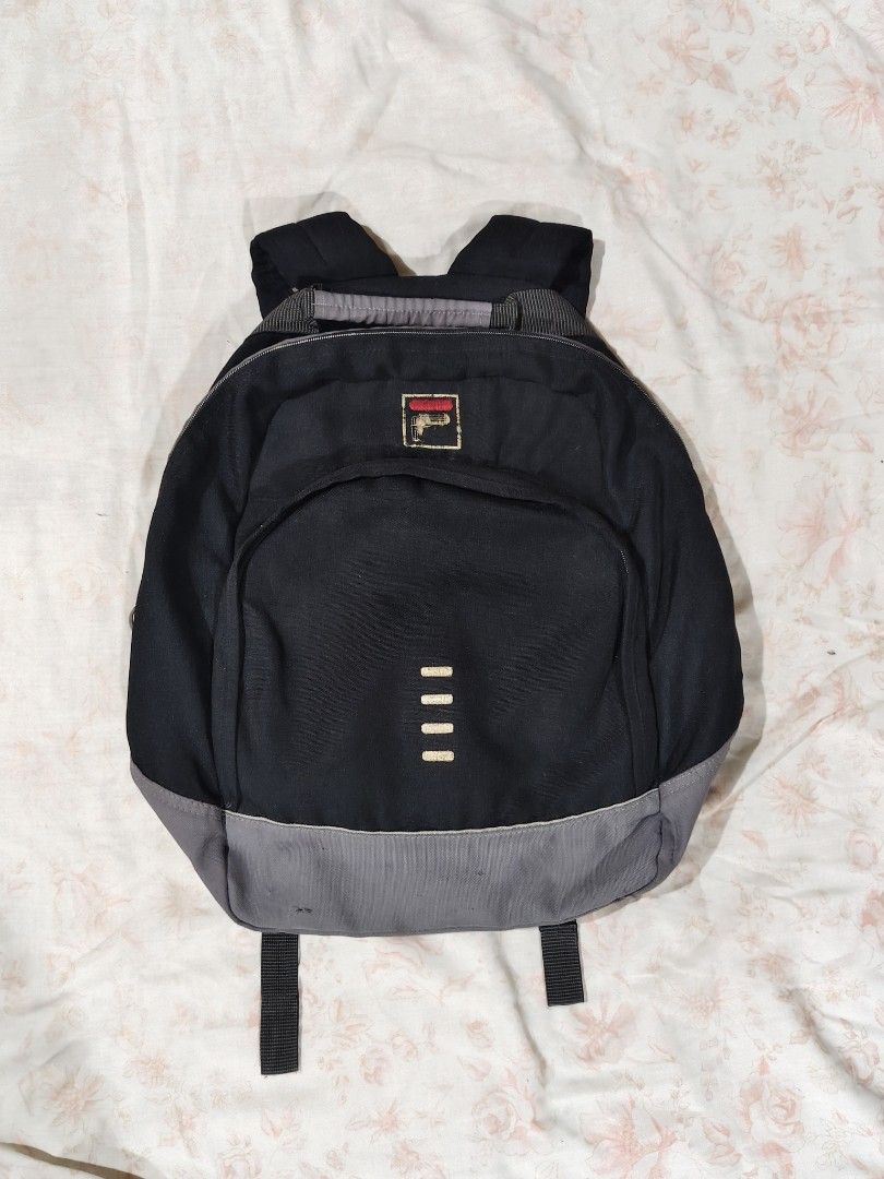 FILA black and gray casual backpack (Category: Backpacks) located in Bulacan. Submitted by angel.decluttersx (Listing ID 1468665047, Image 1). Description: L 17" W 16" all zippers are working no issue please buy at your own risk and manage your expectations.