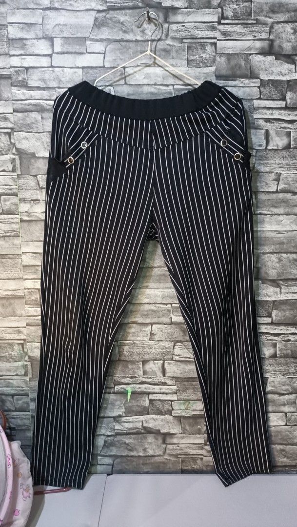 Black and White Pinstripe Pants (Category: Other Bottoms) located in Antipolo. Submitted by reahespiritu (Listing ID 1468651513, Image 1). Description: - Color: Black with all-over white vertical stripes - Waist: Black elastic waistband for easy slip-on wear - Pockets: Two front pockets with metallic buttons and mesh inserts - Fit: Straight-cut legs for a flattering silhouette - Style: Comfortable, versatile for casual or smart-casual outfits.
