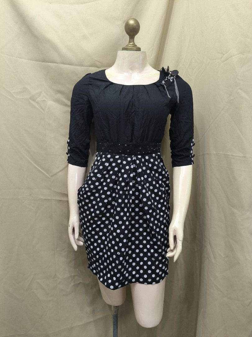 Black and White Polka Dot Dress (Category: Dresses) located in Marikina City. Submitted by mrlfashion23 (Listing ID 1468591059, Image 1). Description: - Style: Black top paired with a white polka dot skirt - Neckline & Sleeves: Scoop neckline with three-quarter sleeves and button accents - Details: Includes a removable decorative brooch on the left shoulder - Fit: Fitted waistline with subtle gathering for a flattering silhouette - Length: Classi