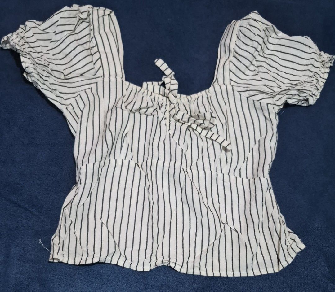 Black and White Striped Puff Sleeve Blouse with Bow (Category: Blouses) located in Imus. Submitted by shopestepanimey (Listing ID 1468554192, Image 1). Description: - Style: Casual, trendy Size small - Pattern: Black and white vertical stripes - Neckline: Square neck with tie-front bow detail - Sleeves: Short puff sleeves with elastic gathered shoulders and cuffs - Fit: Lightweight with a slight waist flare - Versatility: Easy to pair with denim 
