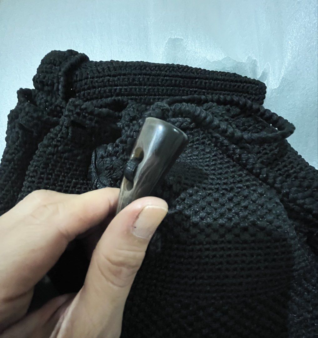 Black Crochet Backpack with Toggle Closure (Category: Backpacks) located in Talisay. Submitted by cherylu (Listing ID 1468699452, Image 2). Description: - Color: Black - Material: Woven crochet - Closure: Flap top with horn-style toggle button and inner drawstring - Details: Cute dangling pom-pom accent - Straps: Double adjustable shoulder straps - Interior: Clean dark fabric lining - Style: Simple, casual everyday carryall.
