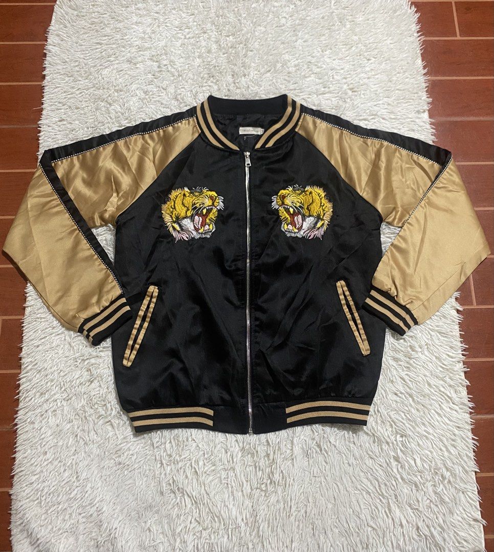 Black Gold Tiger Embroidered Bomber Jacket (Category: Coats, Jackets and Outerwear) located in Calapan. Submitted by heywaiianz (Listing ID 1468557479, Image 2). Description: - Luxury black and gold satin bomber jacket - Detailed tiger head embroidery on chest and back - 'L'Aveugle Par Amour' text embroidery on the back - Front zip closure with two practical front welt pockets - Classic striped ribbed collar, cuffs, and hem for a snug fit - Condi