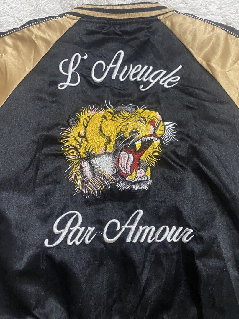 Black Gold Tiger Embroidered Bomber Jacket (Category: Coats, Jackets and Outerwear) located in Calapan. Submitted by heywaiianz (Listing ID 1468557479, Image 3). Description: - Luxury black and gold satin bomber jacket - Detailed tiger head embroidery on chest and back - 'L'Aveugle Par Amour' text embroidery on the back - Front zip closure with two practical front welt pockets - Classic striped ribbed collar, cuffs, and hem for a snug fit - Condi