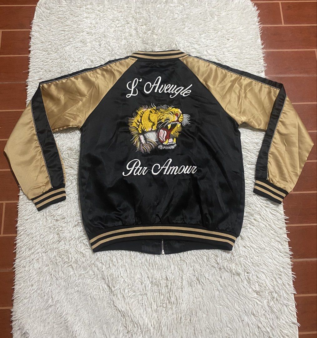 Black Gold Tiger Embroidered Bomber Jacket (Category: Coats, Jackets and Outerwear) located in Calapan. Submitted by heywaiianz (Listing ID 1468557479, Image 1). Description: - Luxury black and gold satin bomber jacket - Detailed tiger head embroidery on chest and back - 'L'Aveugle Par Amour' text embroidery on the back - Front zip closure with two practical front welt pockets - Classic striped ribbed collar, cuffs, and hem for a snug fit - Condi